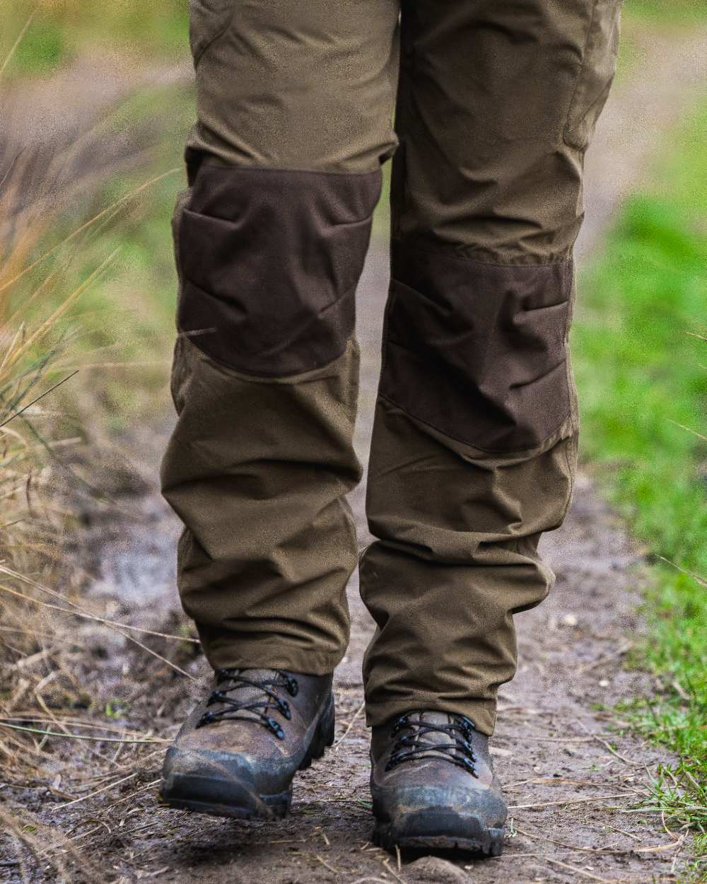 Green coloured Jack Pyke Weardale Hunting Trousers on forest background 