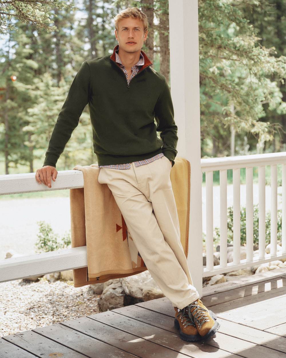 Green coloured Joules Alistair Quarter Zip Cotton Sweatshirt on deck background 