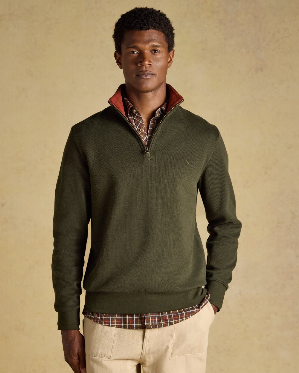 Green coloured Joules Alistair Quarter Zip Cotton Sweatshirt on beige background 