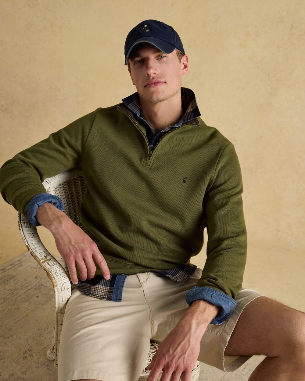 Green Coloured Joules Alistair Quarter Zip Cotton Sweatshirt On A Wall Background 