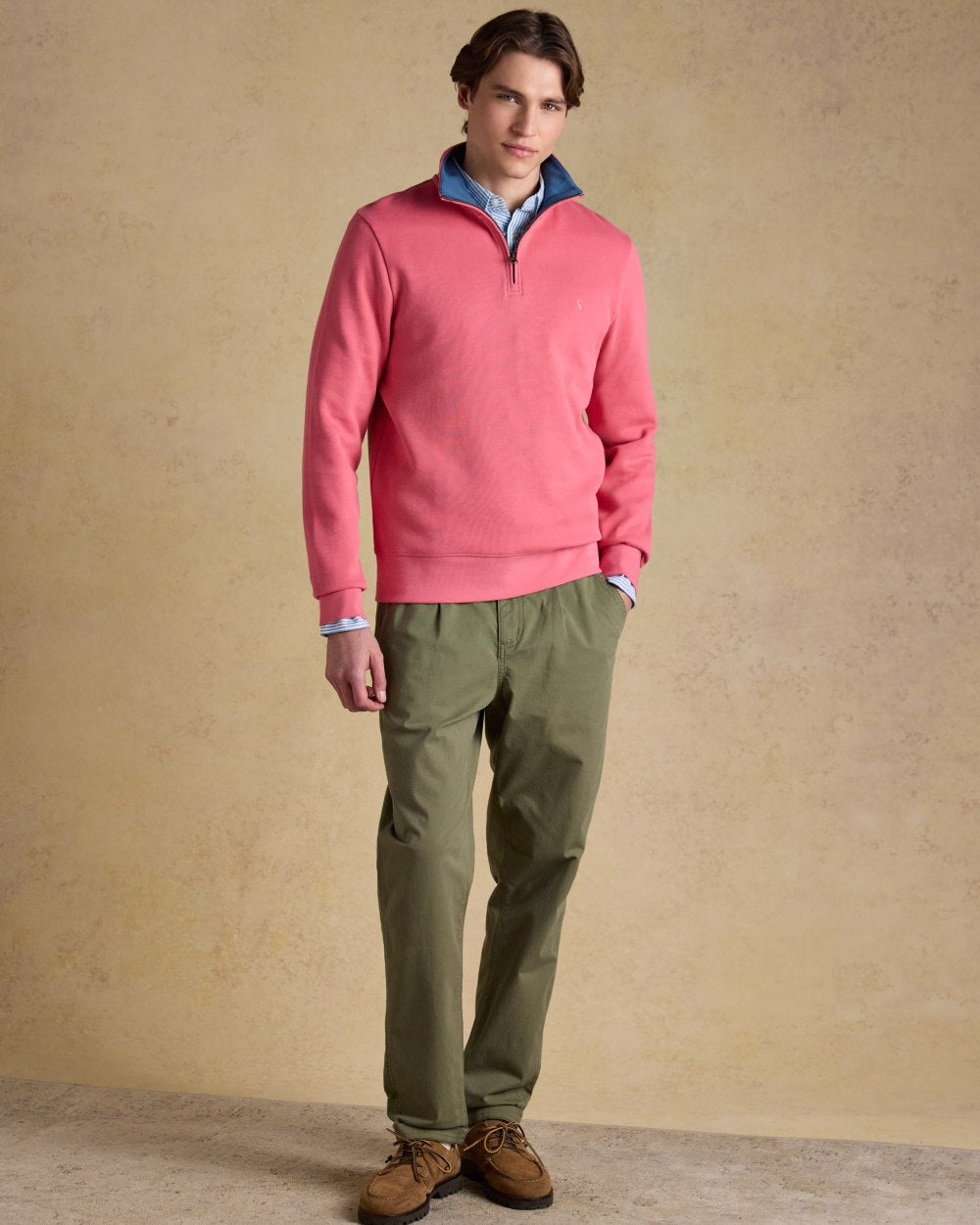 Pink coloured Joules Alistair Quarter Zip Cotton Sweatshirt on wall background 