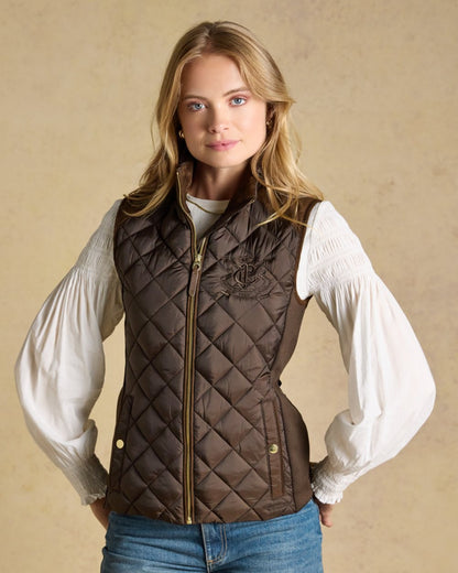 Chocolate Brown coloured Joules Braemar Luxe Gilet on tan background 