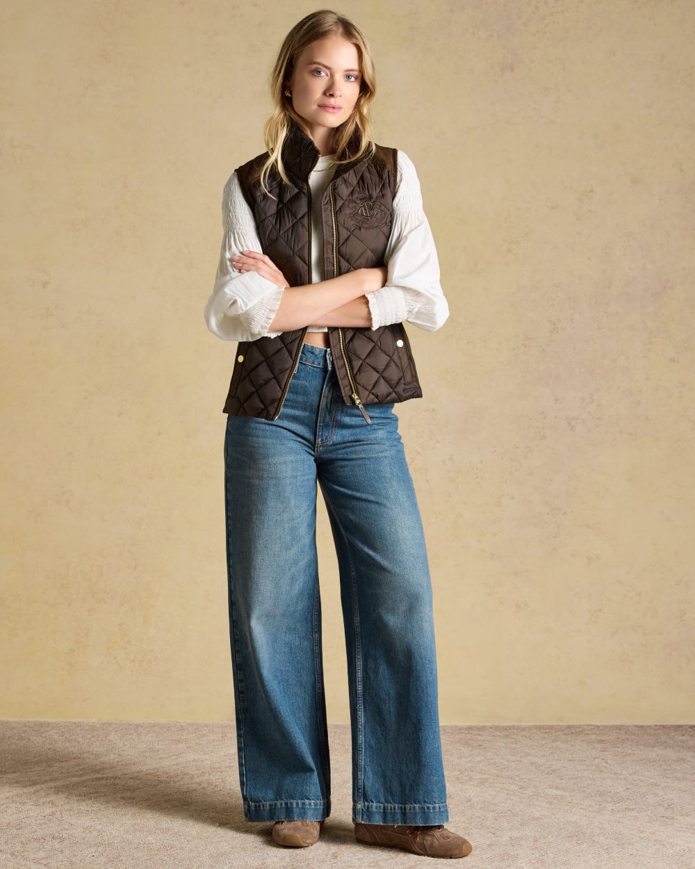 Chocolate Brown coloured Joules Braemar Luxe Gilet on tan background 
