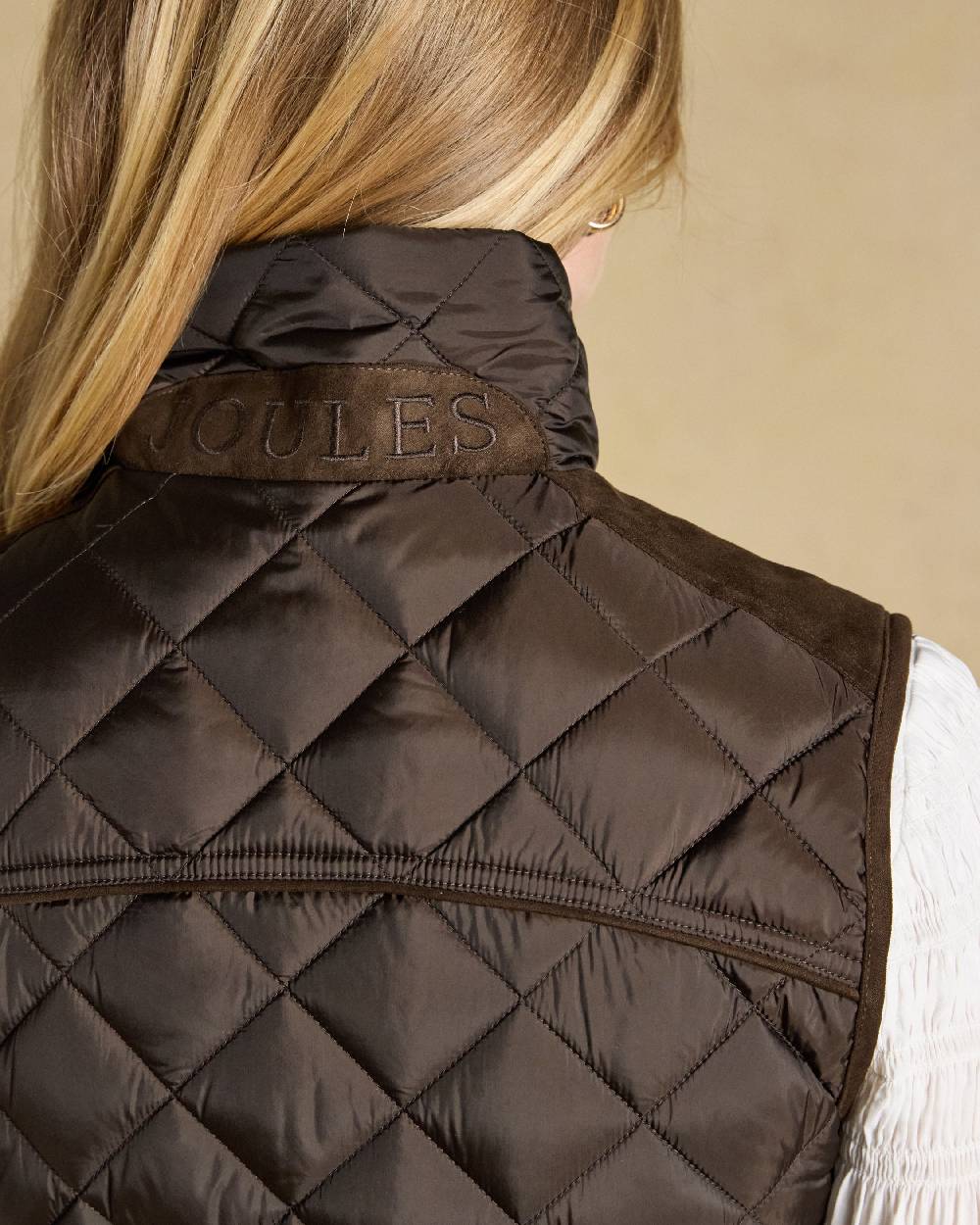 Chocolate Brown coloured Joules Braemar Luxe Gilet on tan background 