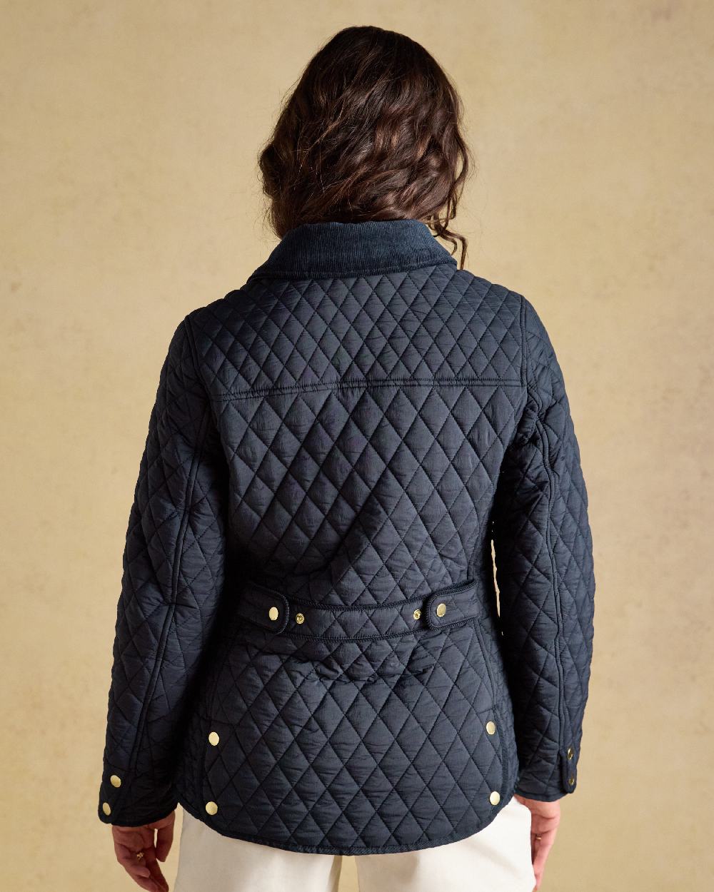 Navy coloured Joules Highclere Jacket on tan background 
