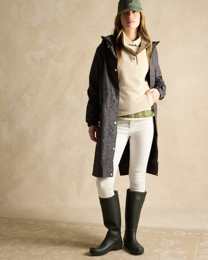 Black Coloured Joules Holkham Waterproof Packable Raincoat With Hood on indoor background 