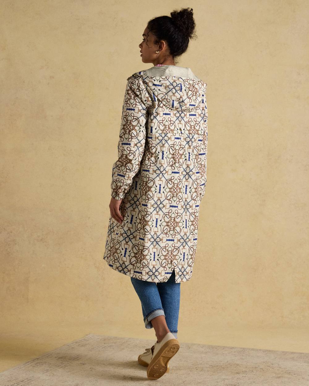 Stone Coloured Joules Holkham Waterproof Packable Raincoat With Hood on indoor background 