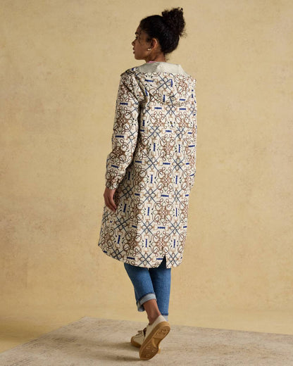 Stone Coloured Joules Holkham Waterproof Packable Raincoat With Hood on indoor background 