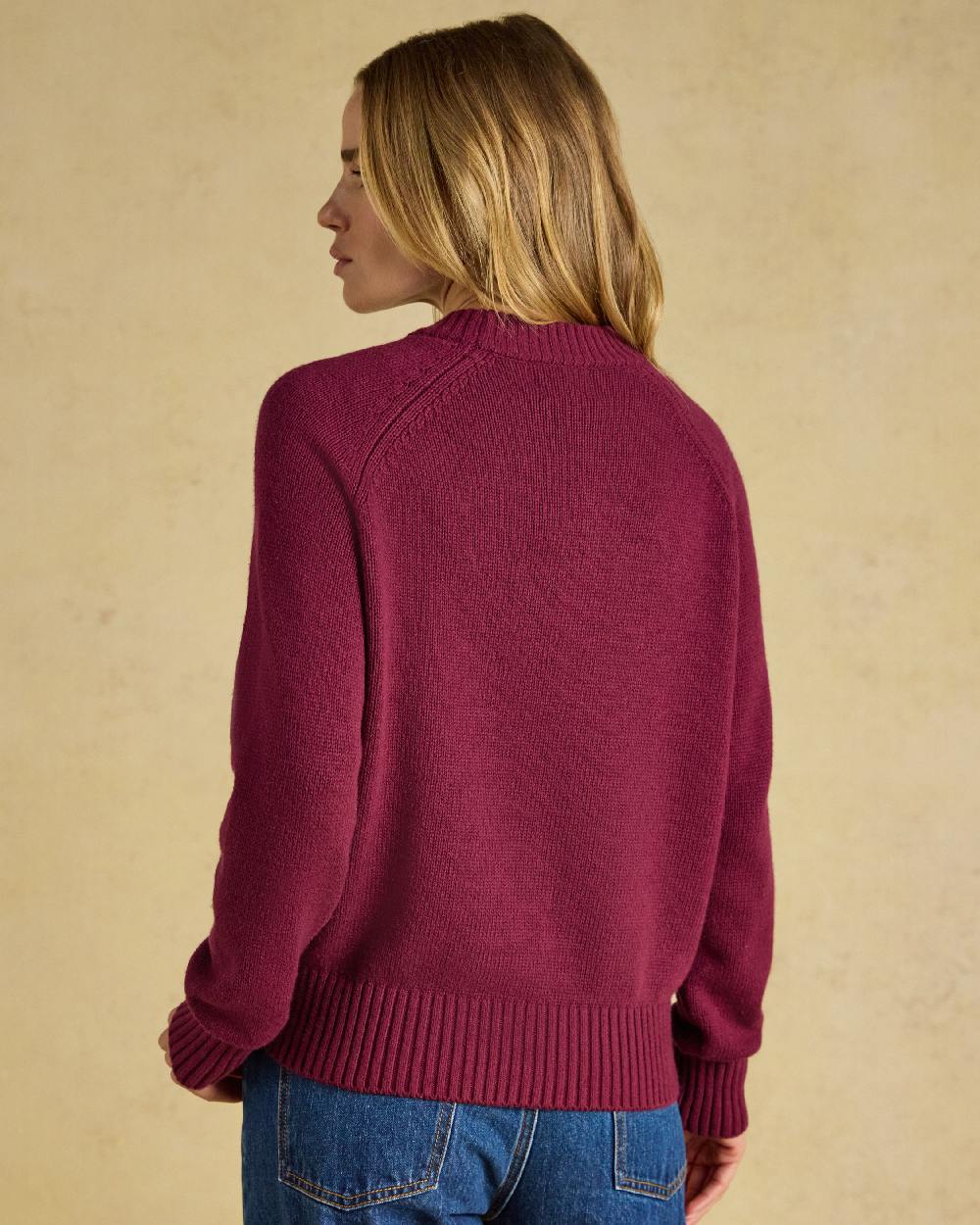 Burgundy Red Coloured Joules Jonty Intarsia Knit Jumper on beige background 