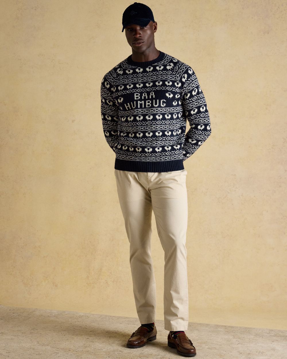 Navy Coloured Joules Mens Baa Humbug Intarsia Christmas Jumper on indoor background 