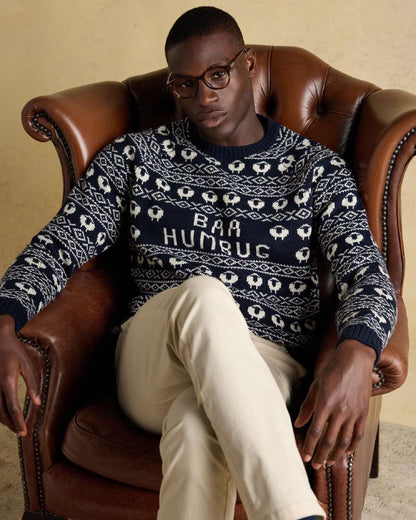 Navy Coloured Joules Mens Baa Humbug Intarsia Christmas Jumper on indoor background 