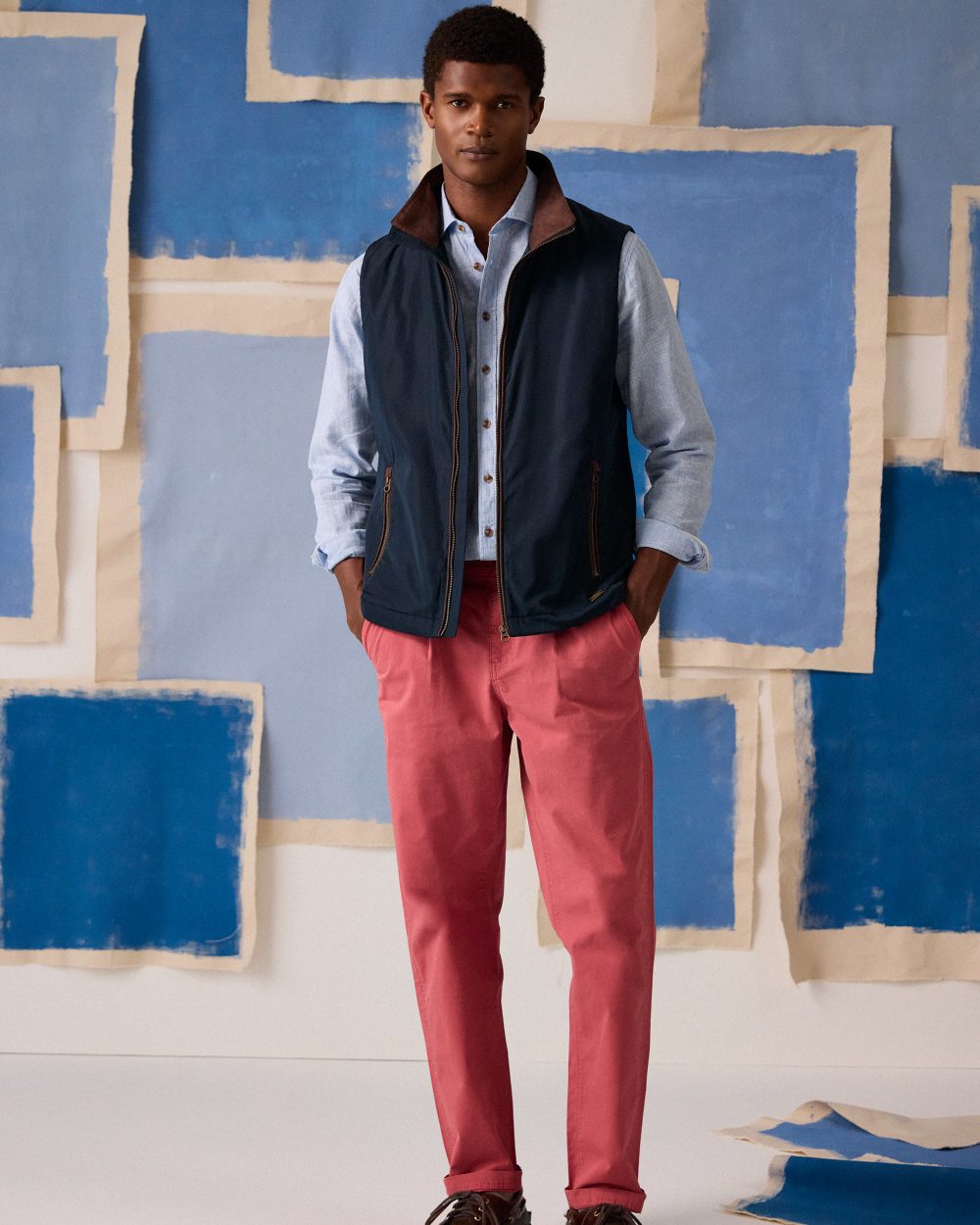 Navy coloured Joules Mens Farnham Padded Fleece Lined Gilet on wall background 