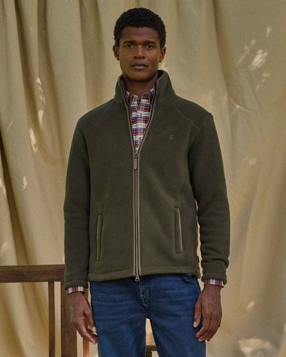 Dark Green Coloured Joules Mens Heritage Full Zip Through Fleece on curtain background 