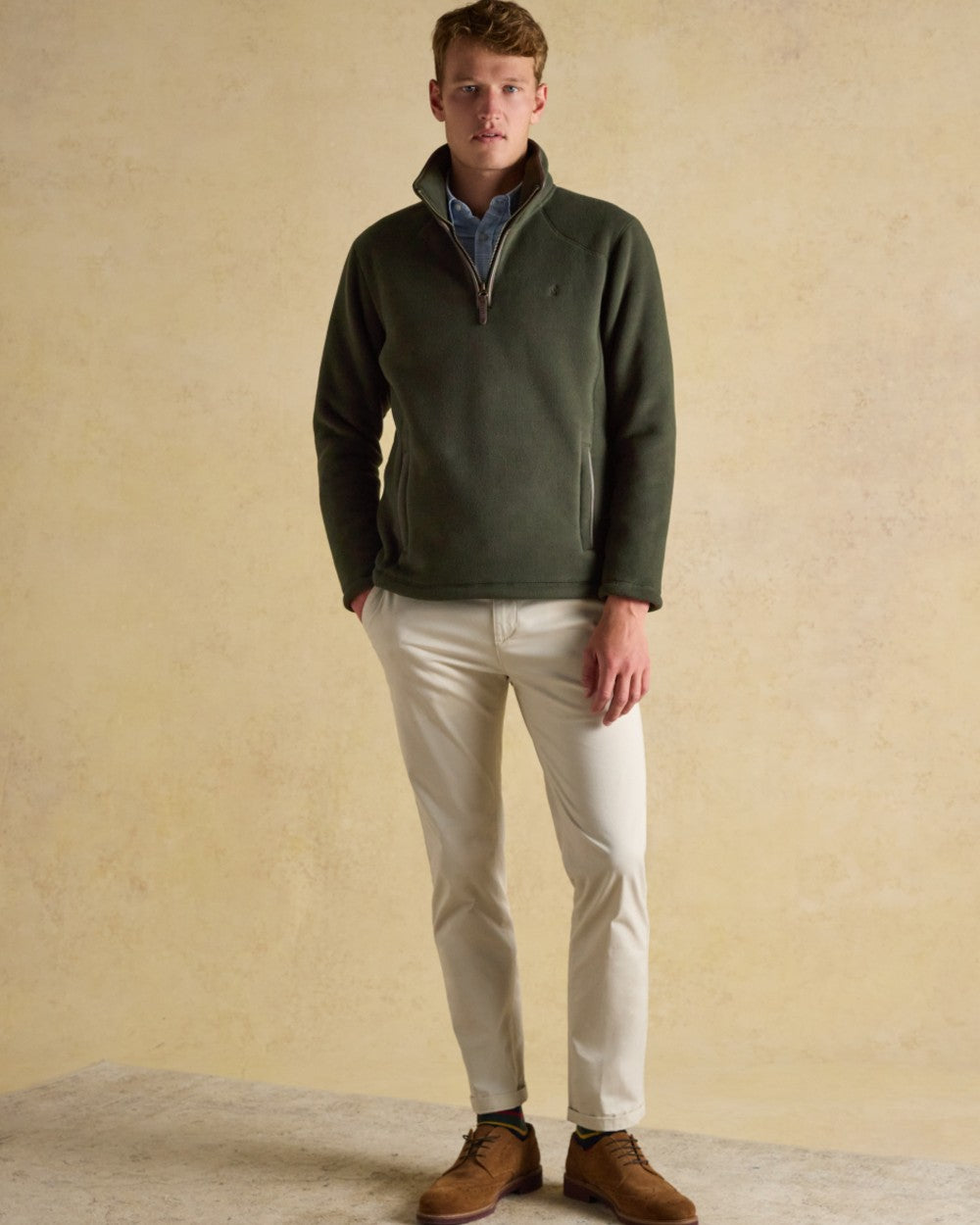 Dark Green Coloured Joules Mens Heritage Quarter Zip Fleece on wall background 