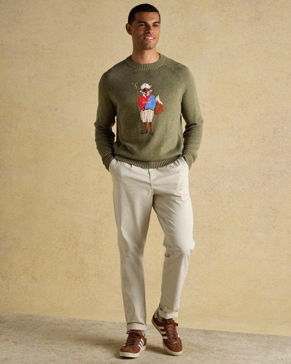 Khaki Green Coloured Joules Mens Jonty Intarsia Crew Knit Jumper on wall background 
