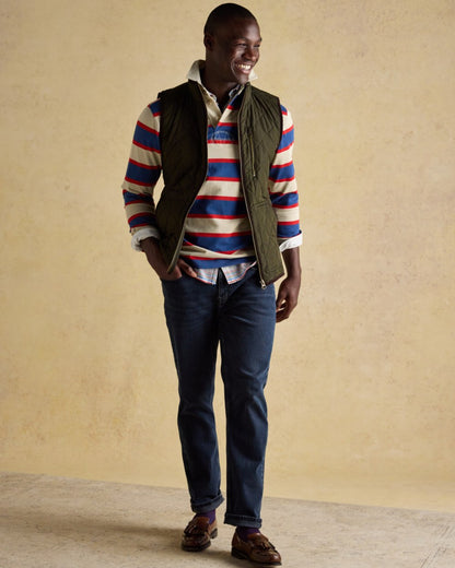 Green coloured Joules Mens Maynard Diamond Quilted Gilet on wall background 