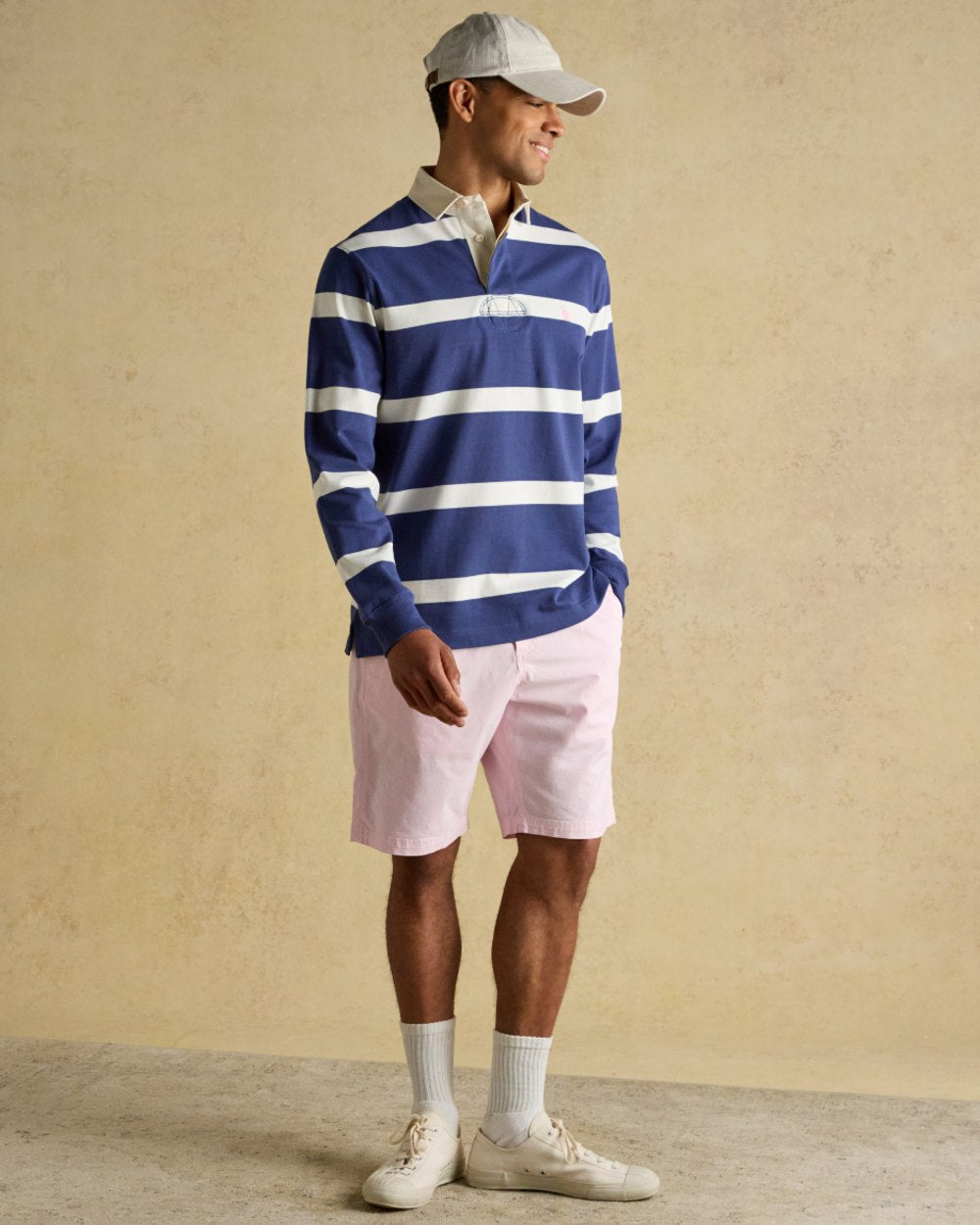 Blue Cream Coloured Joules Mens Onside Rugby Shirt on wall background 