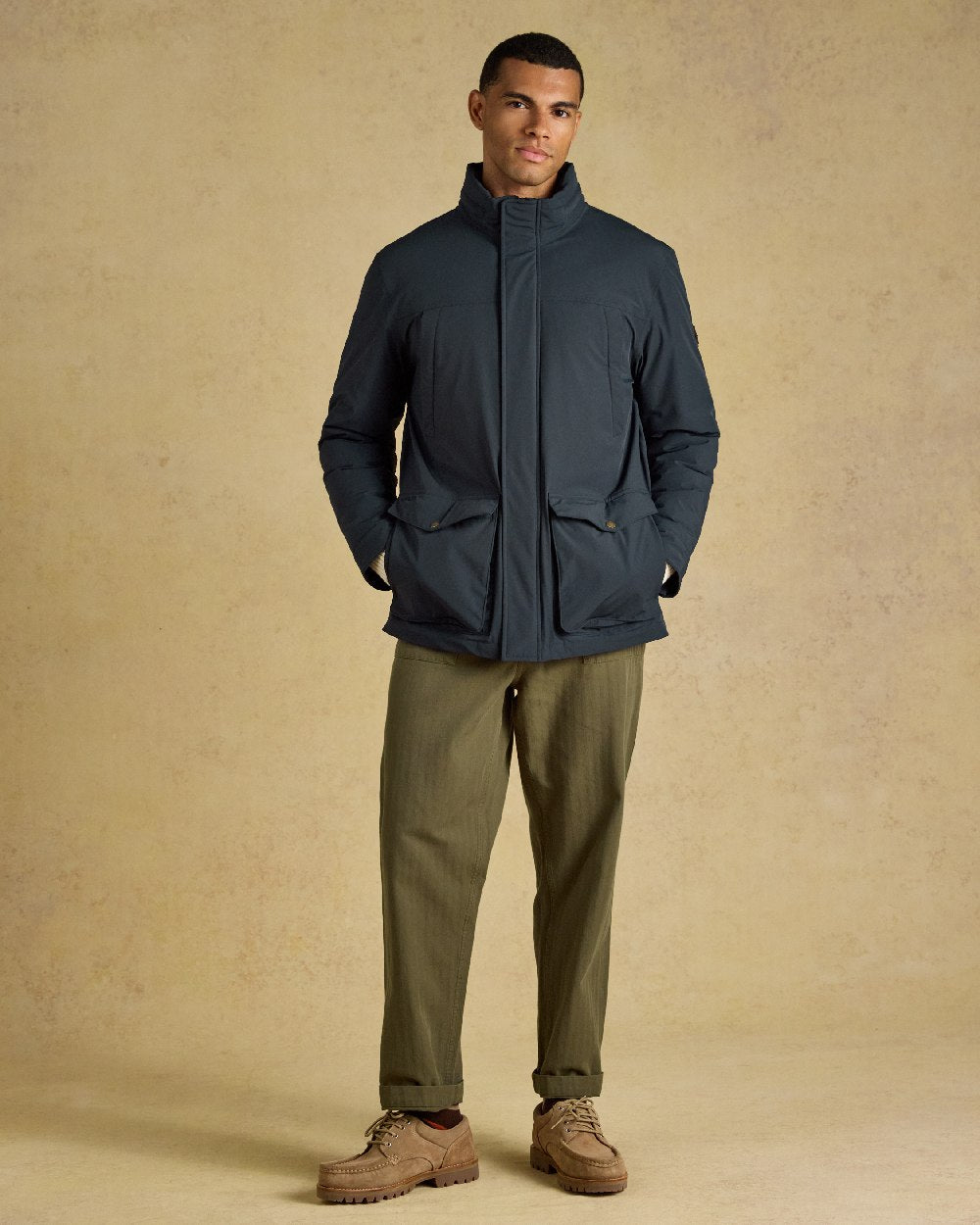 Navy Coloured Joules Mens Padded Waterproof Field Coat on Beige Background 