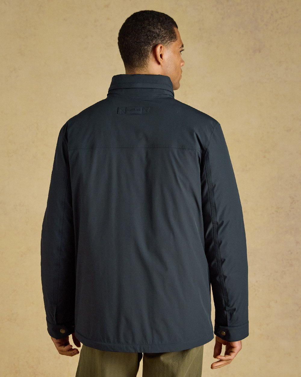 Navy Coloured Joules Mens Padded Waterproof Field Coat on Beige Background 
