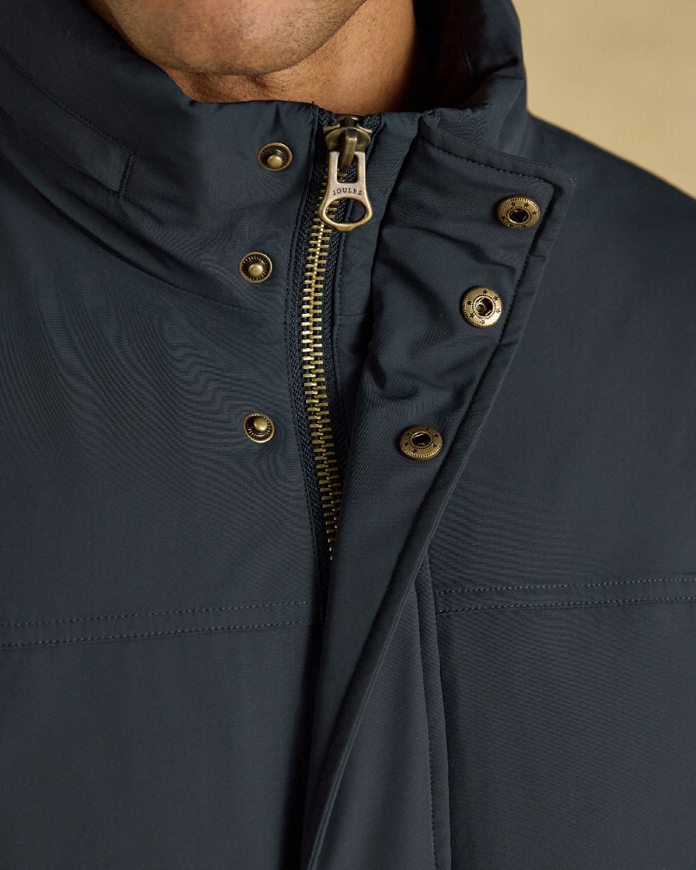 Navy Coloured Joules Mens Padded Waterproof Field Coat on Beige Background 