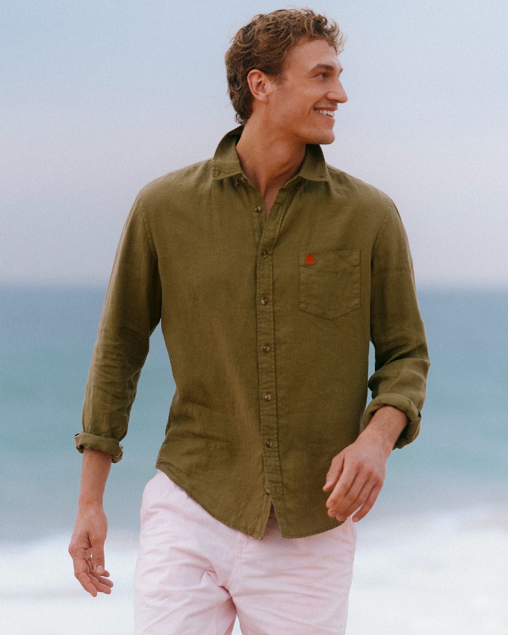 Khaki Green coloured Joules Mens Pure Linen Long Sleeve Classic Fit Shirt on sea background 