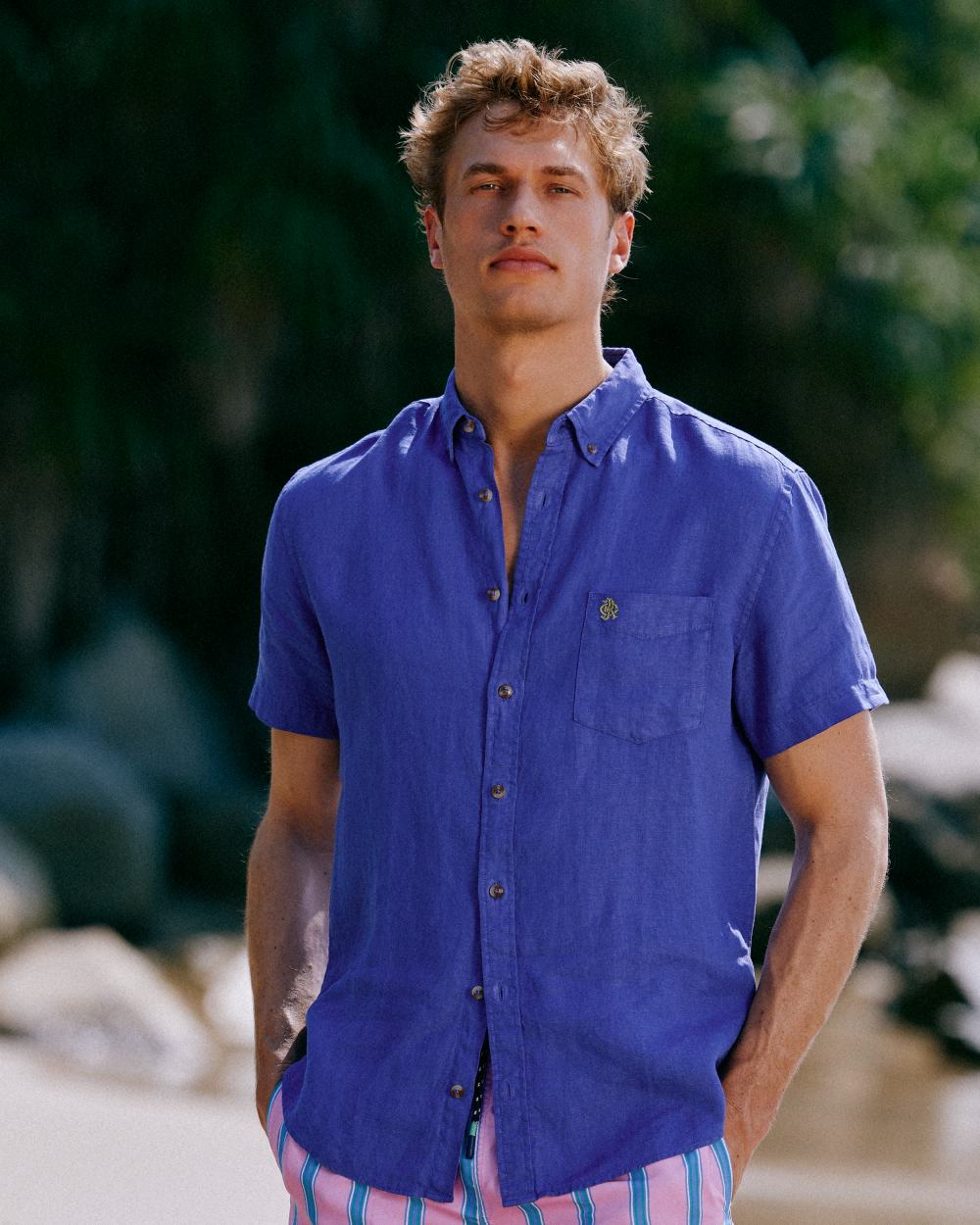 Blue coloured Joules Mens Pure Linen Short Sleeve Classic Fit Shirt on outdoor background 