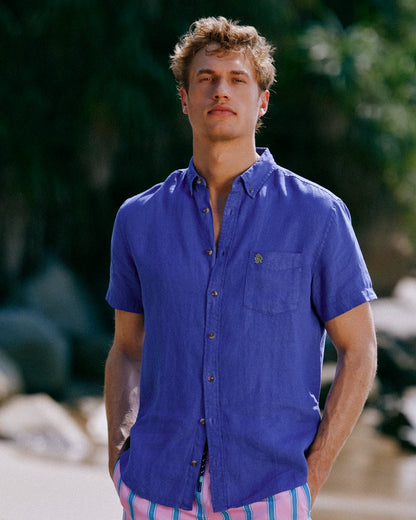 Blue coloured Joules Mens Pure Linen Short Sleeve Classic Fit Shirt on outdoor background 
