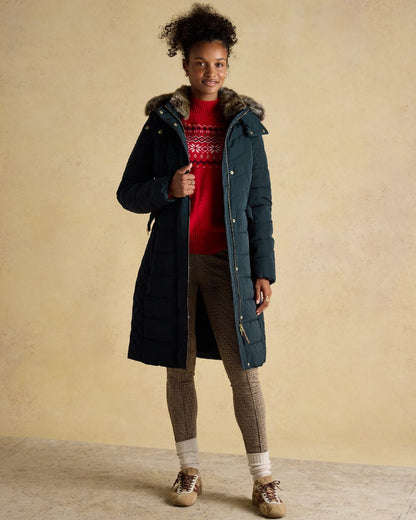 Navy Coloured Joules Womens Aspen Long Showerproof Padded Coat on indoor background 