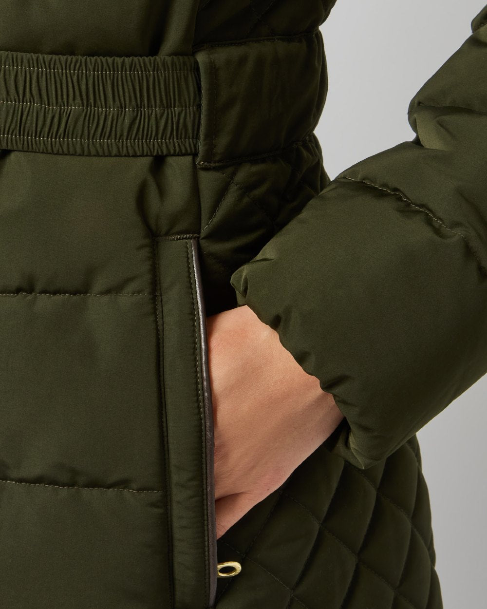 Dark Green coloured Joules Womens Aspen Showerproof Longline Padded Coat on grey background 