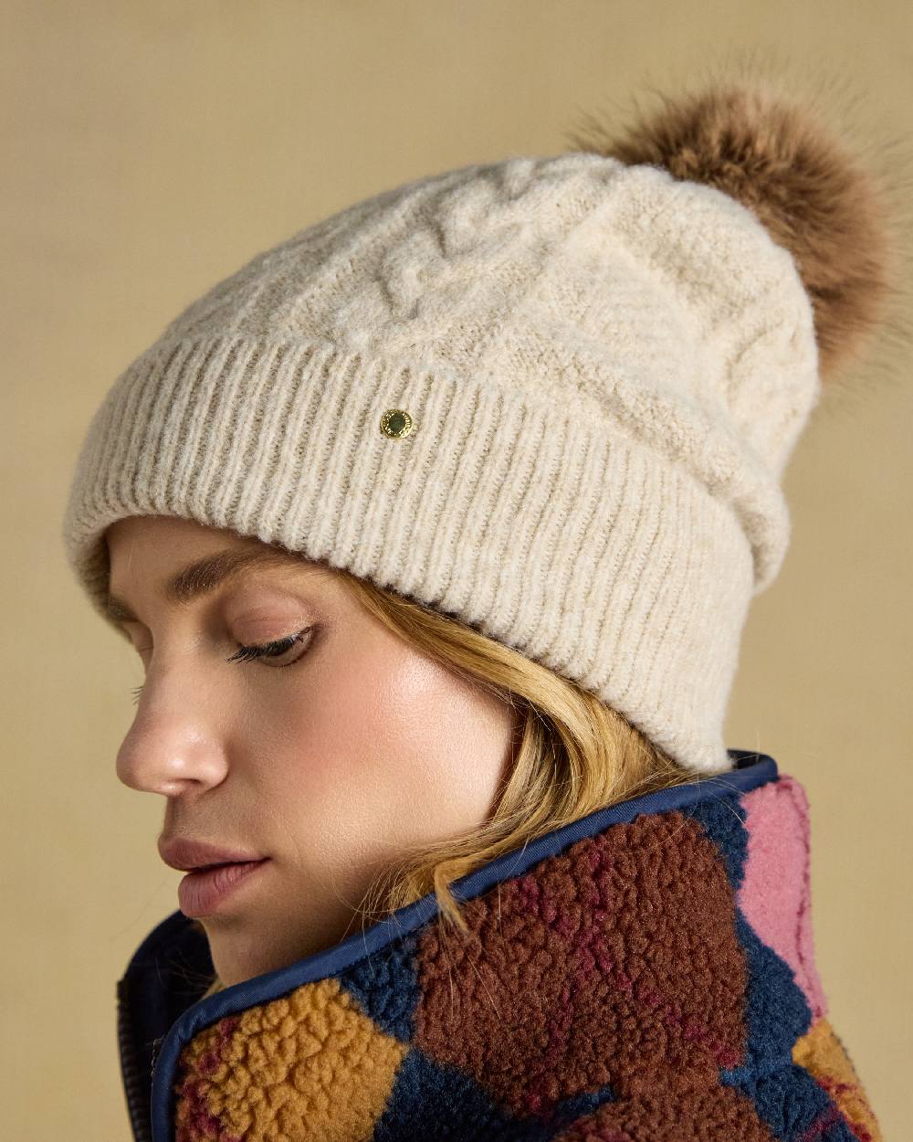 Oatmeal Coloured Joules Womens Cable Bobble Hat on Cream Background 