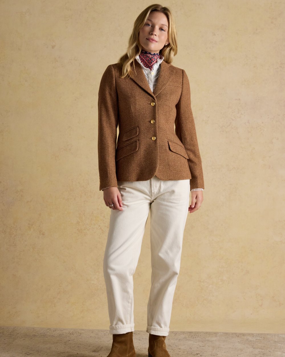 Brown Herringbone coloured Joules Womens Canterly Tweed Hacking Jacket on wall background 