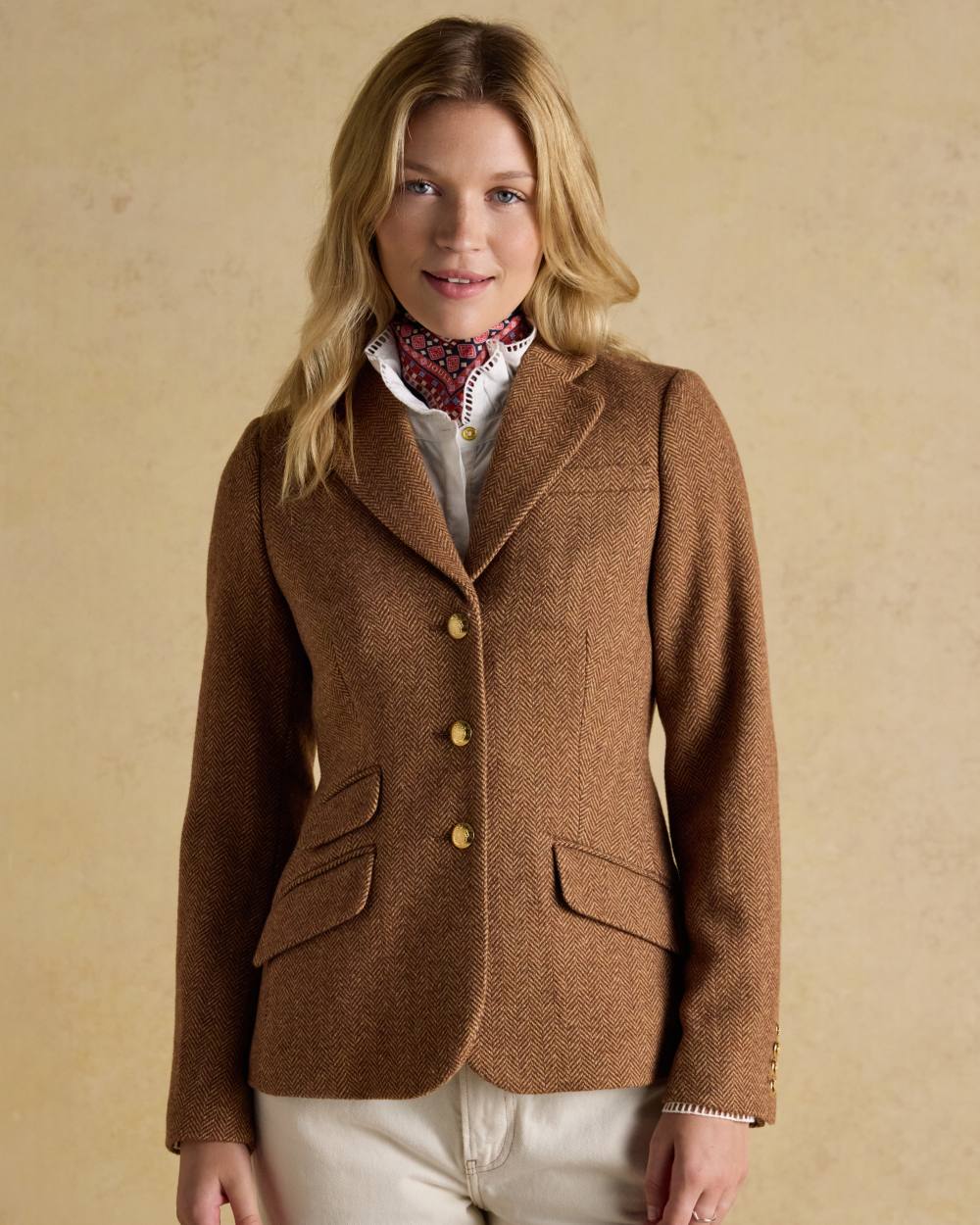 Brown Herringbone coloured Joules Womens Canterly Tweed Hacking Jacket on wall background 