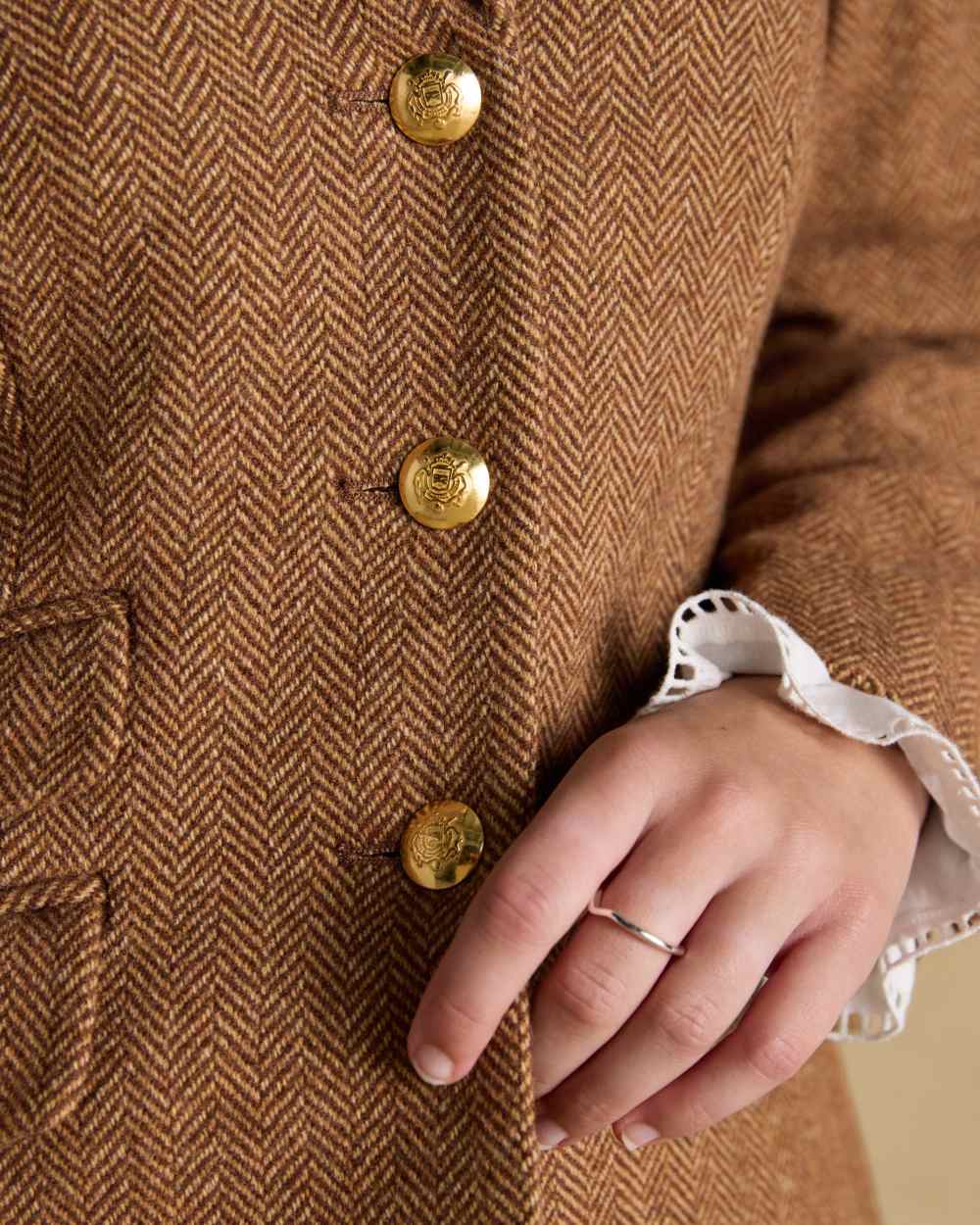 Brown Herringbone coloured Joules Womens Canterly Tweed Hacking Jacket on wall background 