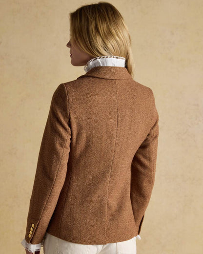 Brown Herringbone coloured Joules Womens Canterly Tweed Hacking Jacket on wall background 