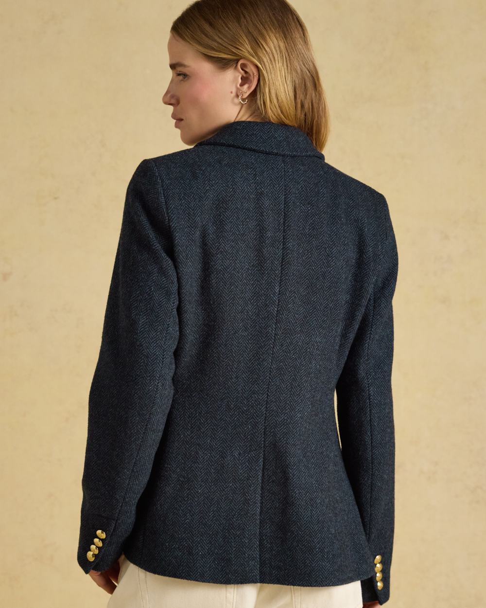 Navy coloured Joules Womens Canterly Tweed Hacking Jacket on indoor background 