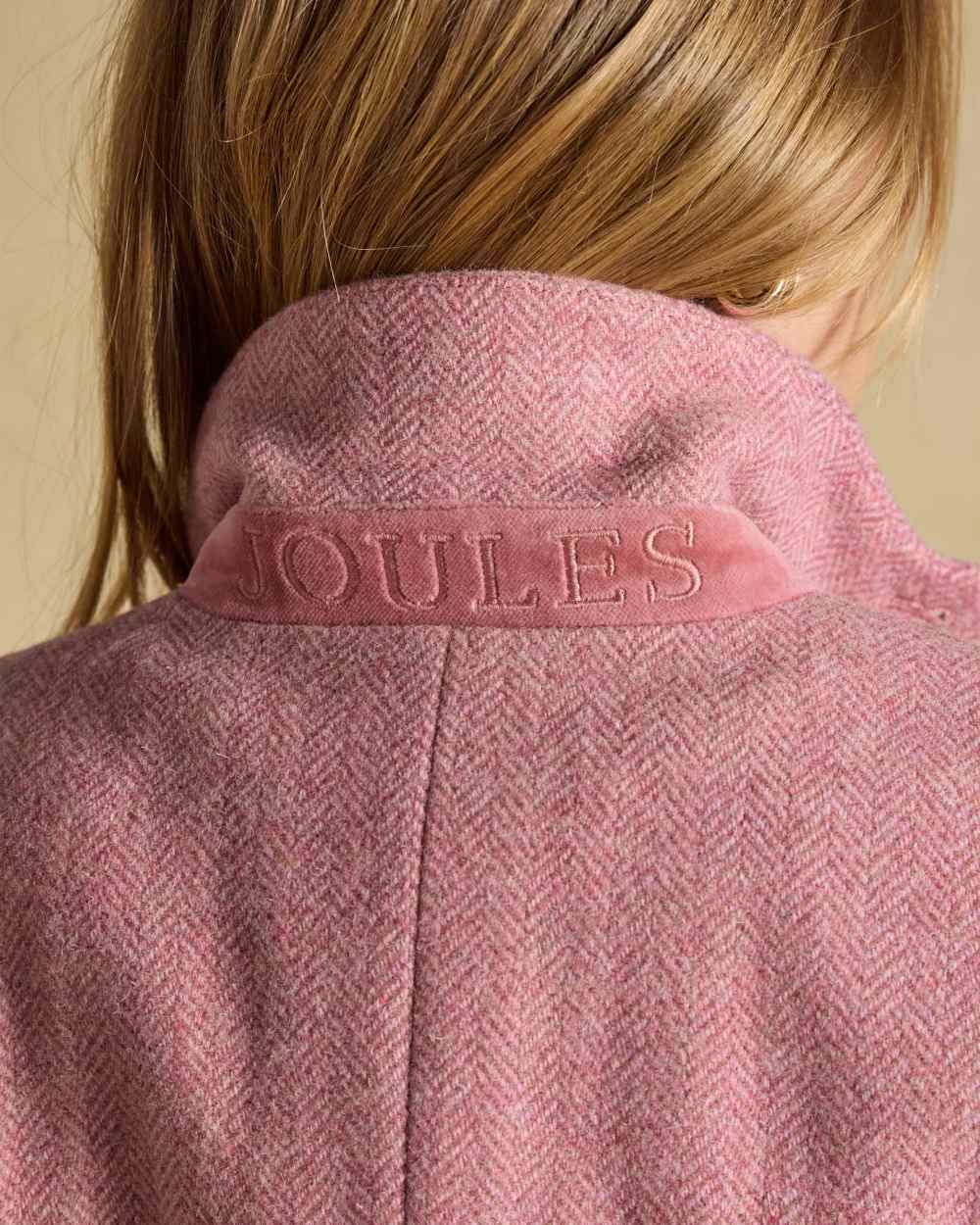 Pink coloured Joules Womens Canterly Tweed Hacking Jacket on wall background 
