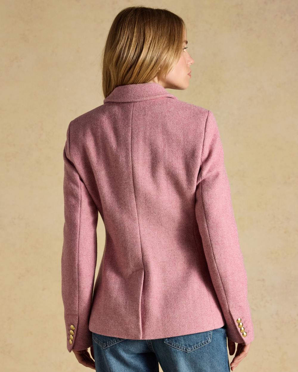 Pink coloured Joules Womens Canterly Tweed Hacking Jacket on wall background 