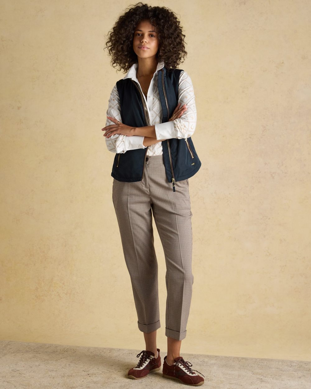Navy coloured Joules Womens Farnham Fleece Lined Lightweight Gilet on wall background 