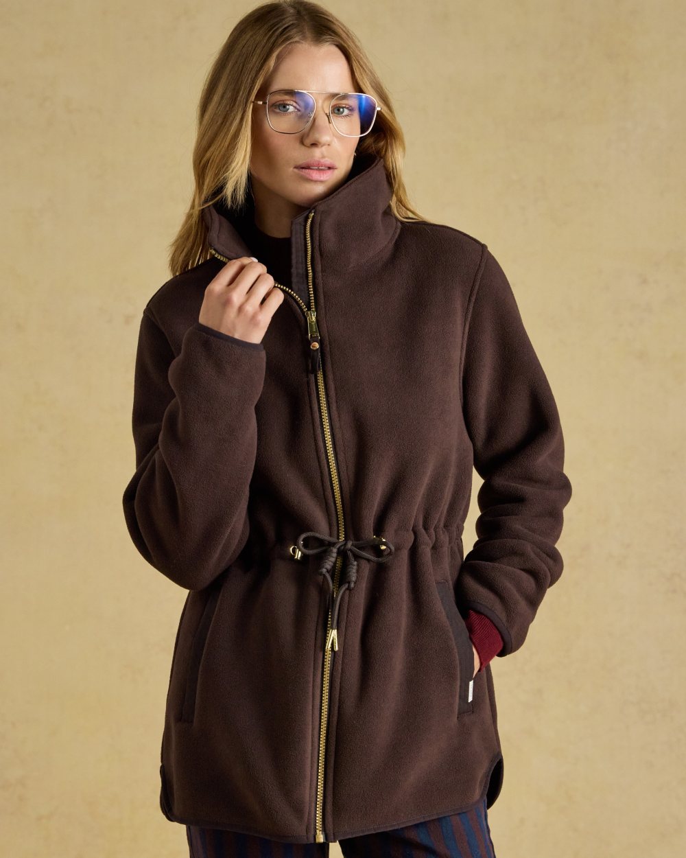 Chocolate Brown coloured Joules Womens Full Zip Longline Fleece Jacket on indoor background 