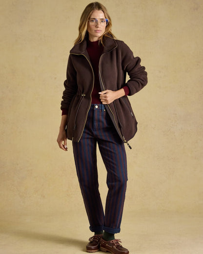Chocolate Brown coloured Joules Womens Full Zip Longline Fleece Jacket on indoor background 