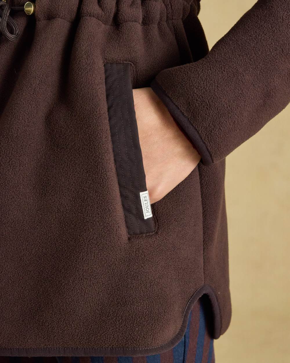 Chocolate Brown coloured Joules Womens Full Zip Longline Fleece Jacket on indoor background 