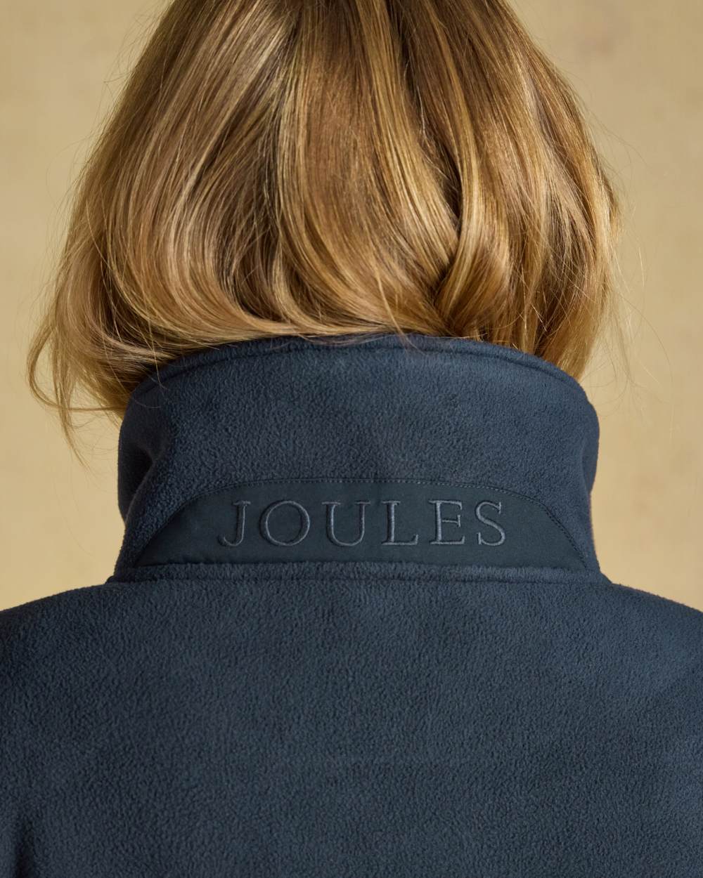 Navy coloured Joules Womens Full Zip Longline Fleece Jacket on indoor background 