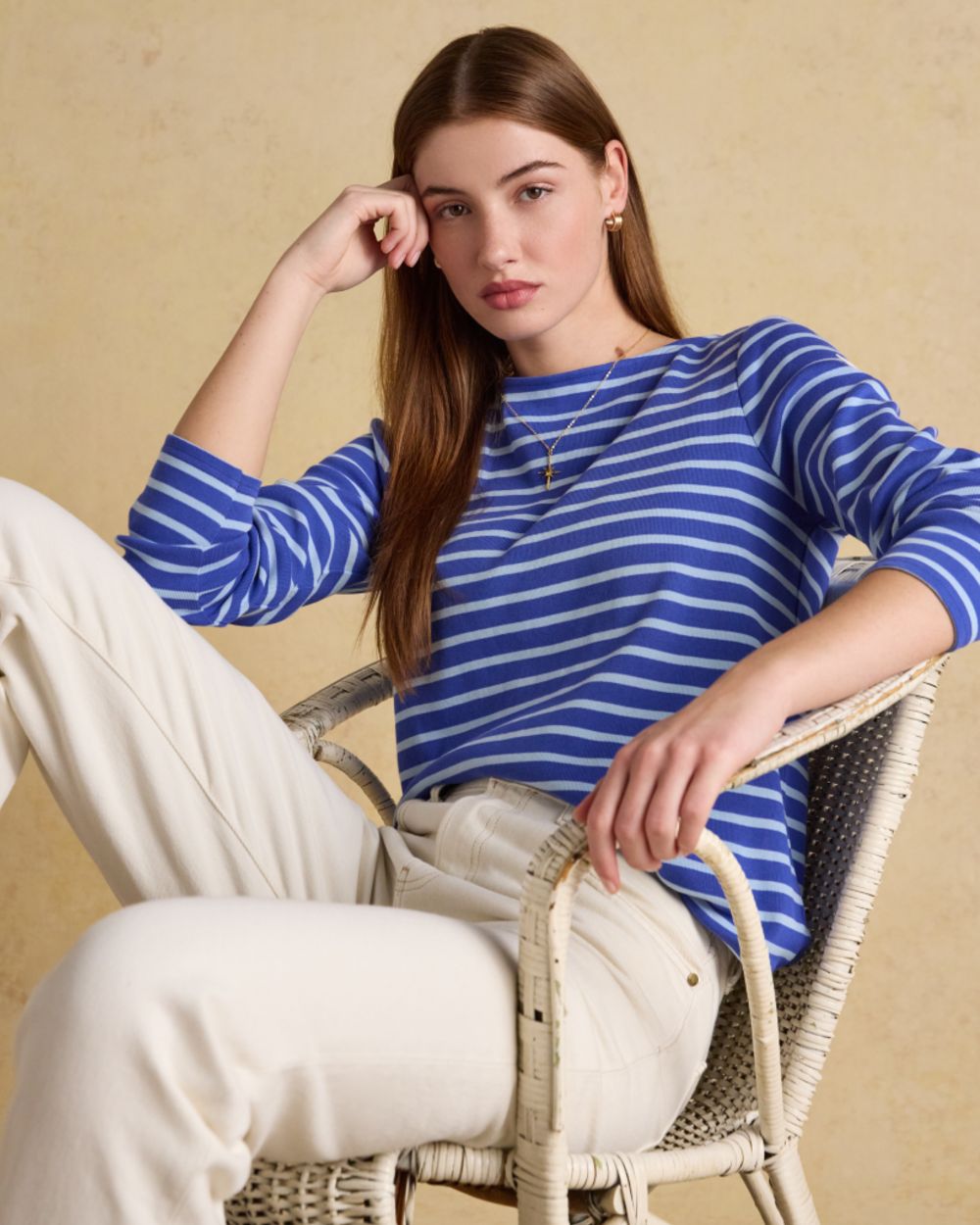 Blue Navy Stripe coloured Joules Womens Harbour Long Sleeve Striped Boat Neck Breton Top on wall background 