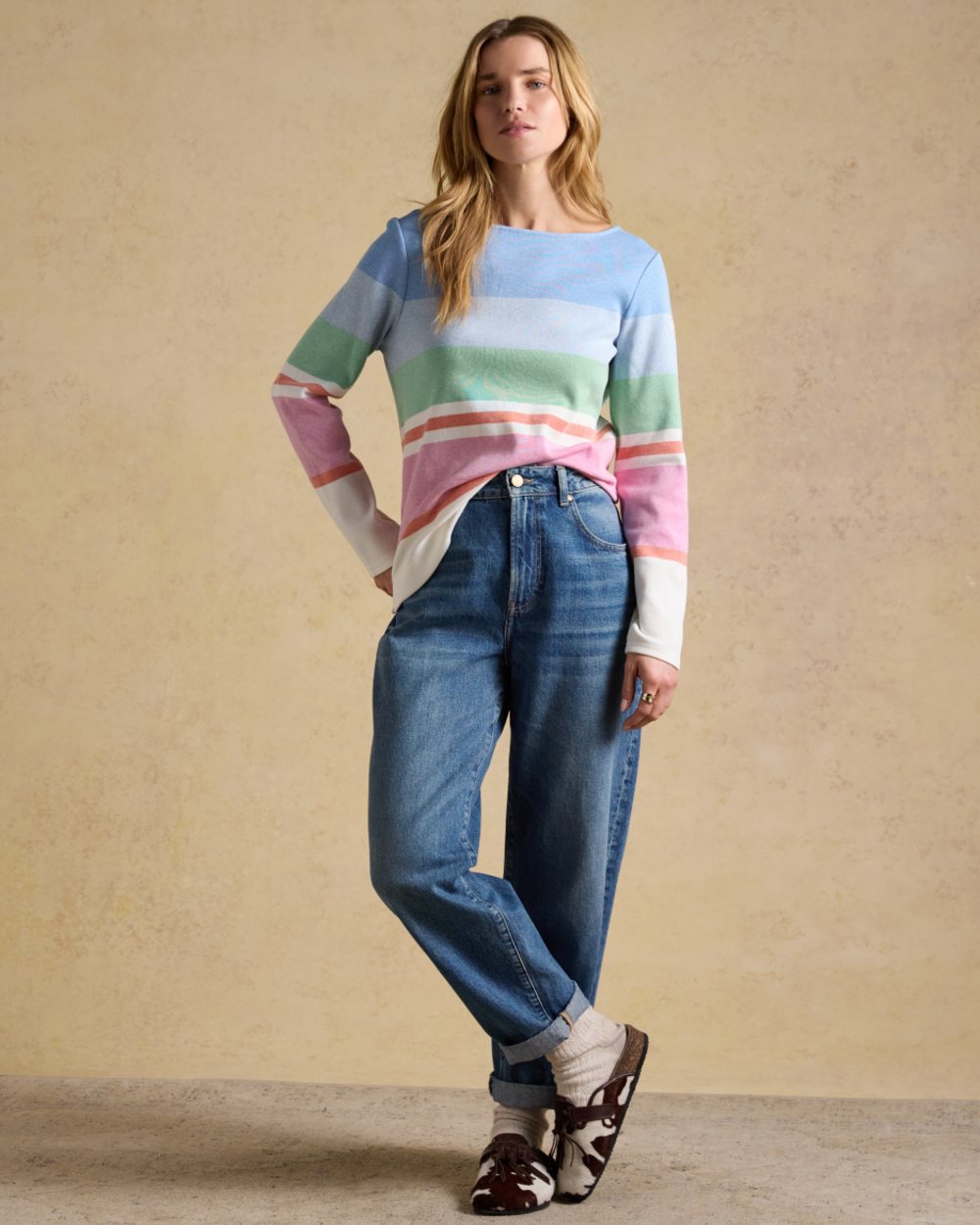 Cream Multi Stripe coloured Joules Womens Harbour Long Sleeve Striped Boat Neck Breton Top on wall background 