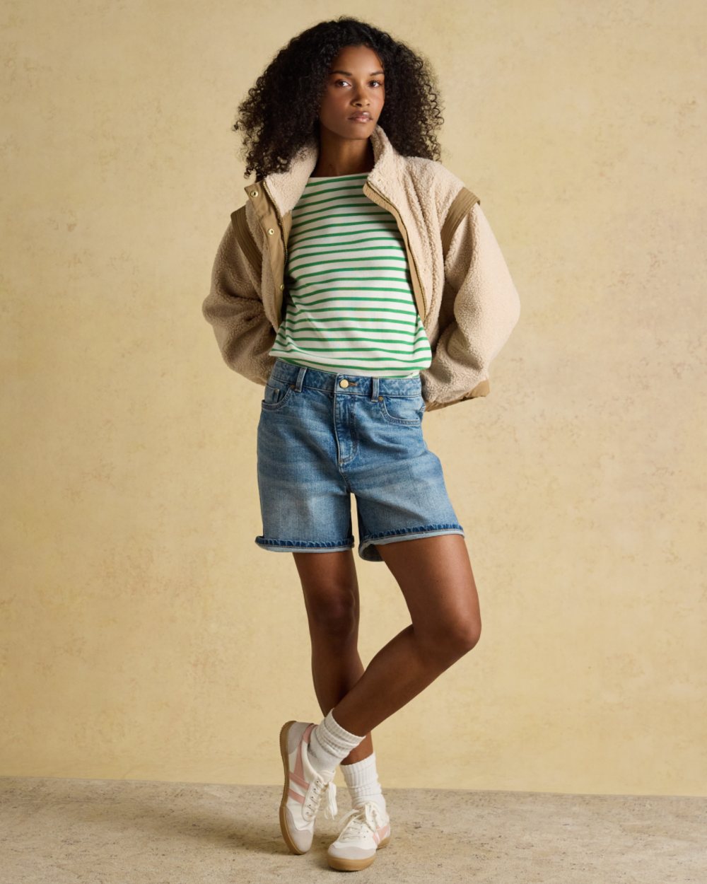 Green Stripe coloured Joules Womens Harbour Long Sleeve Striped Boat Neck Breton Top on wall background 