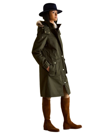 Khaki Green Coloured Joules Womens Harpsden Cosy Waterproof Fleece Lined Raincoat With Faux Fur Hood on white background 