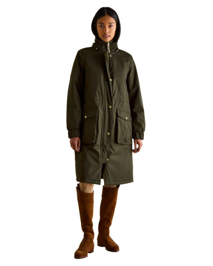 Khaki Green Coloured Joules Womens Harpsden Cosy Waterproof Fleece Lined Raincoat With Faux Fur Hood on white background 