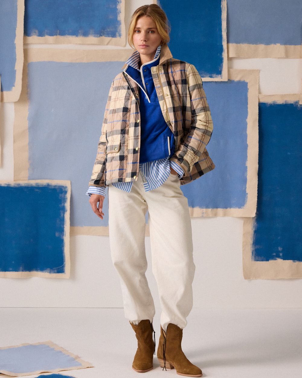 Brown check coloured Joules Womens Harrogate Showerproof Diamond Quilted Barn Jacket on wall background 