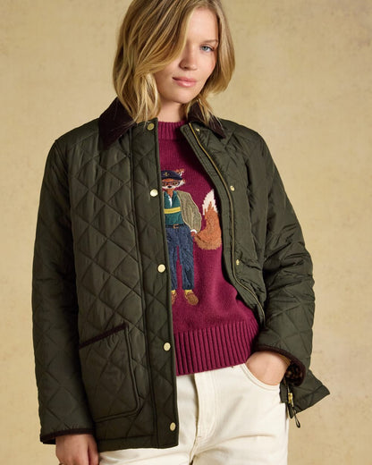 Khaki Green coloured Joules Womens Highgrove Diamond Quilted Jacket on beige background 