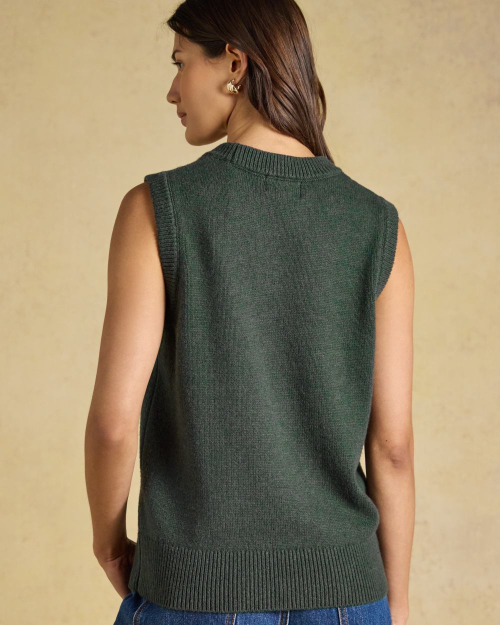 Green coloured Joules Womens Jonty Sleeveless Knitted Vest on indoor background 
